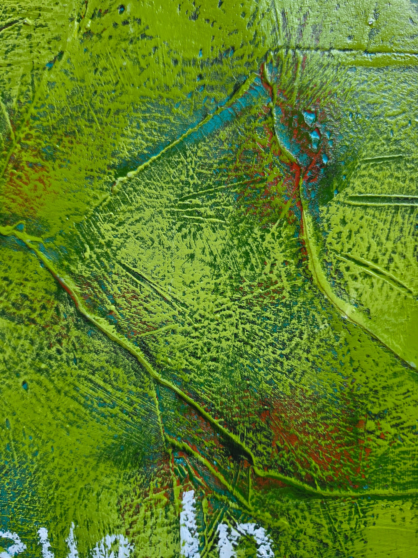 Abstract painting in green with green and red pops of colour in underneath layers with texture