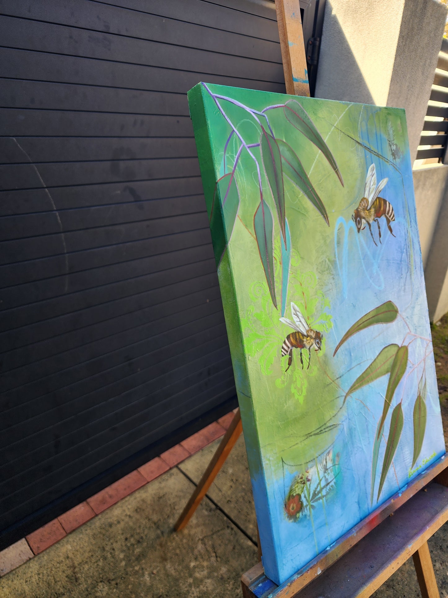 Painting of bees and leaves on a green background side view