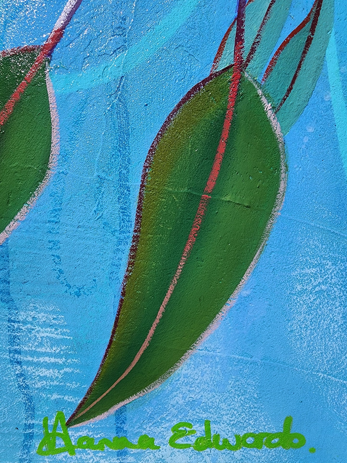 Artistic depiction of green leaves with red veins on a blue textured background, signed 'Hanna Edwards'.