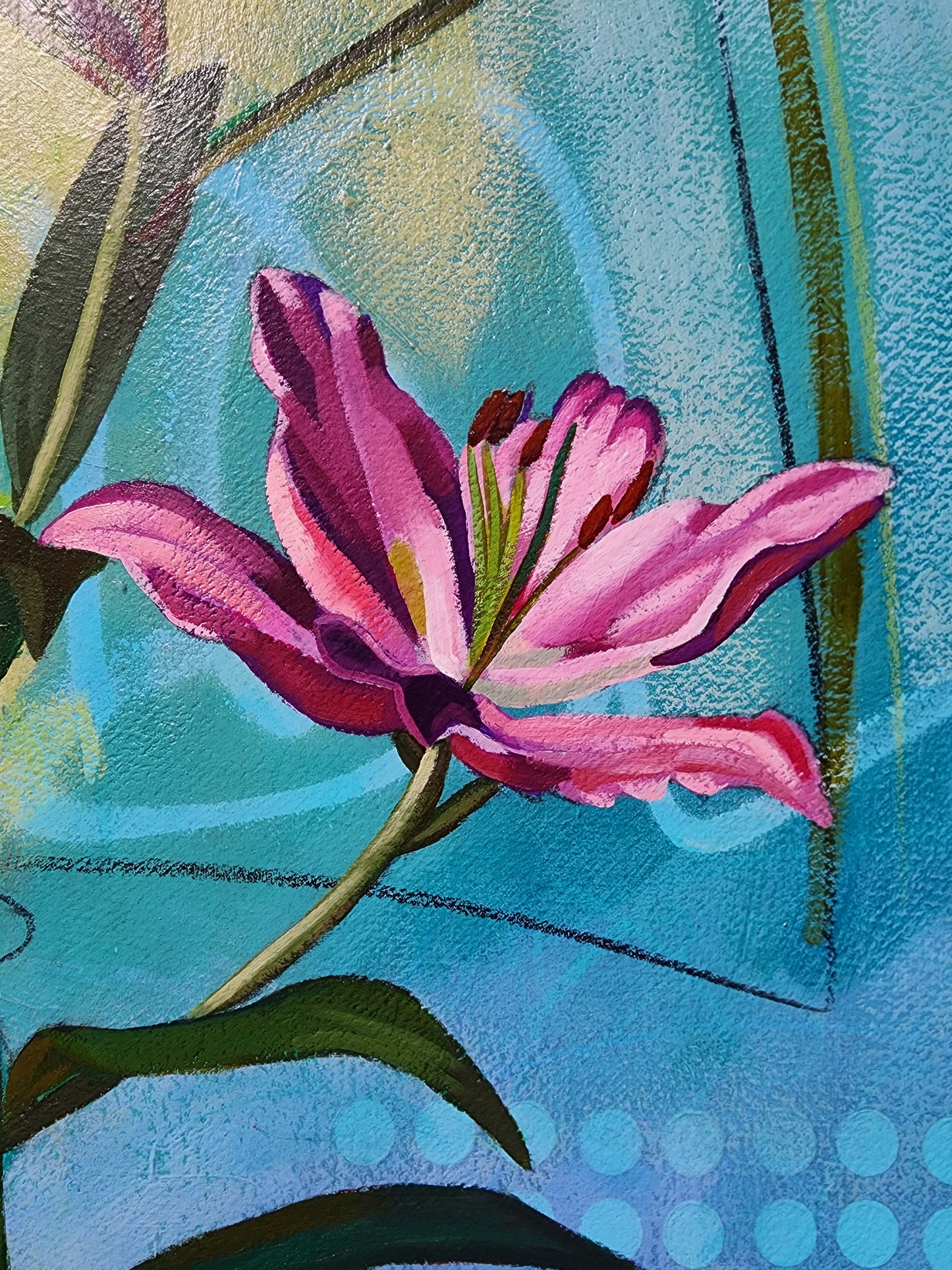 Close-up of a pink flower with green leaves on a textured blue background