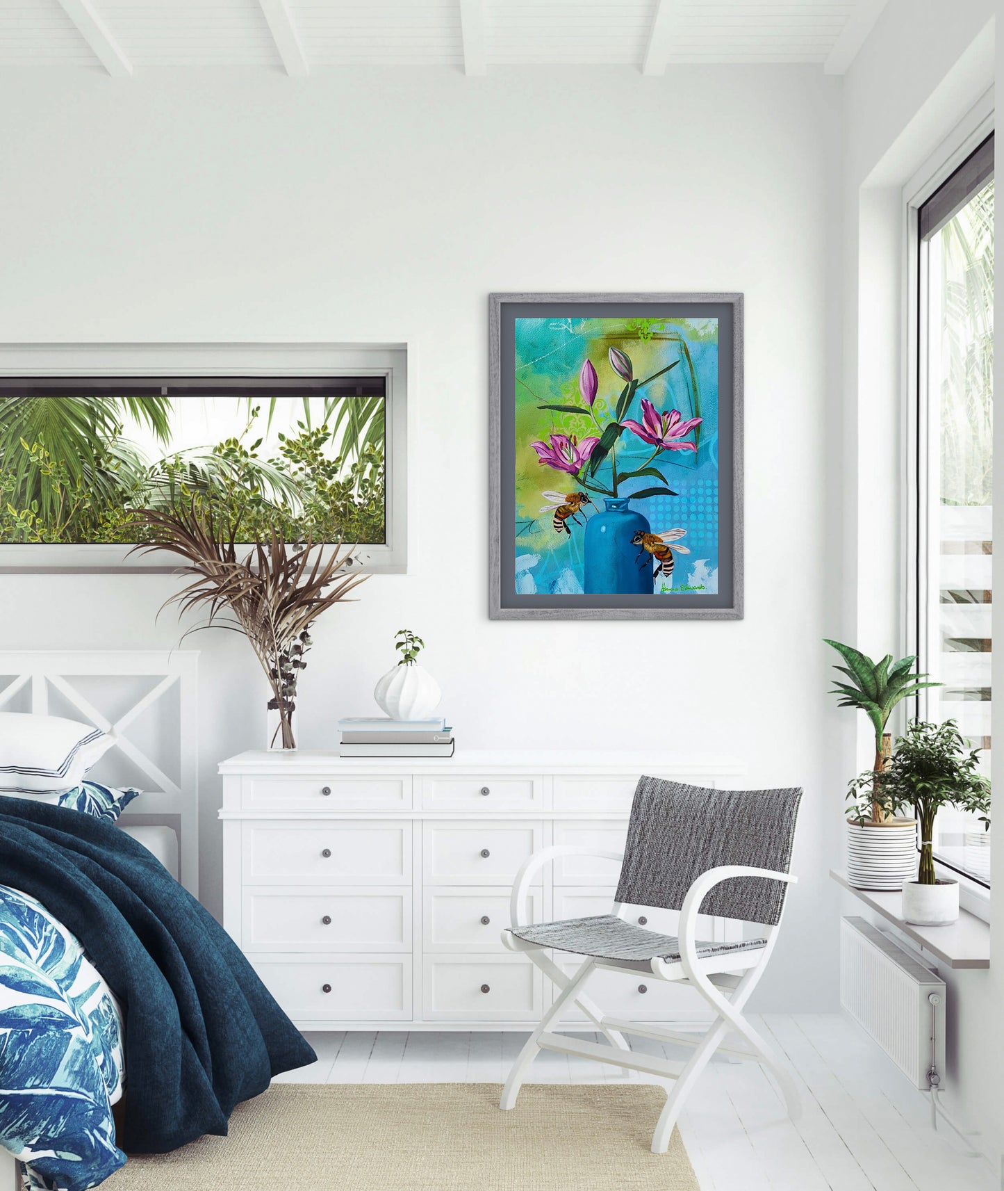 Modern bedroom with white dresser, chair, and decorative elements.