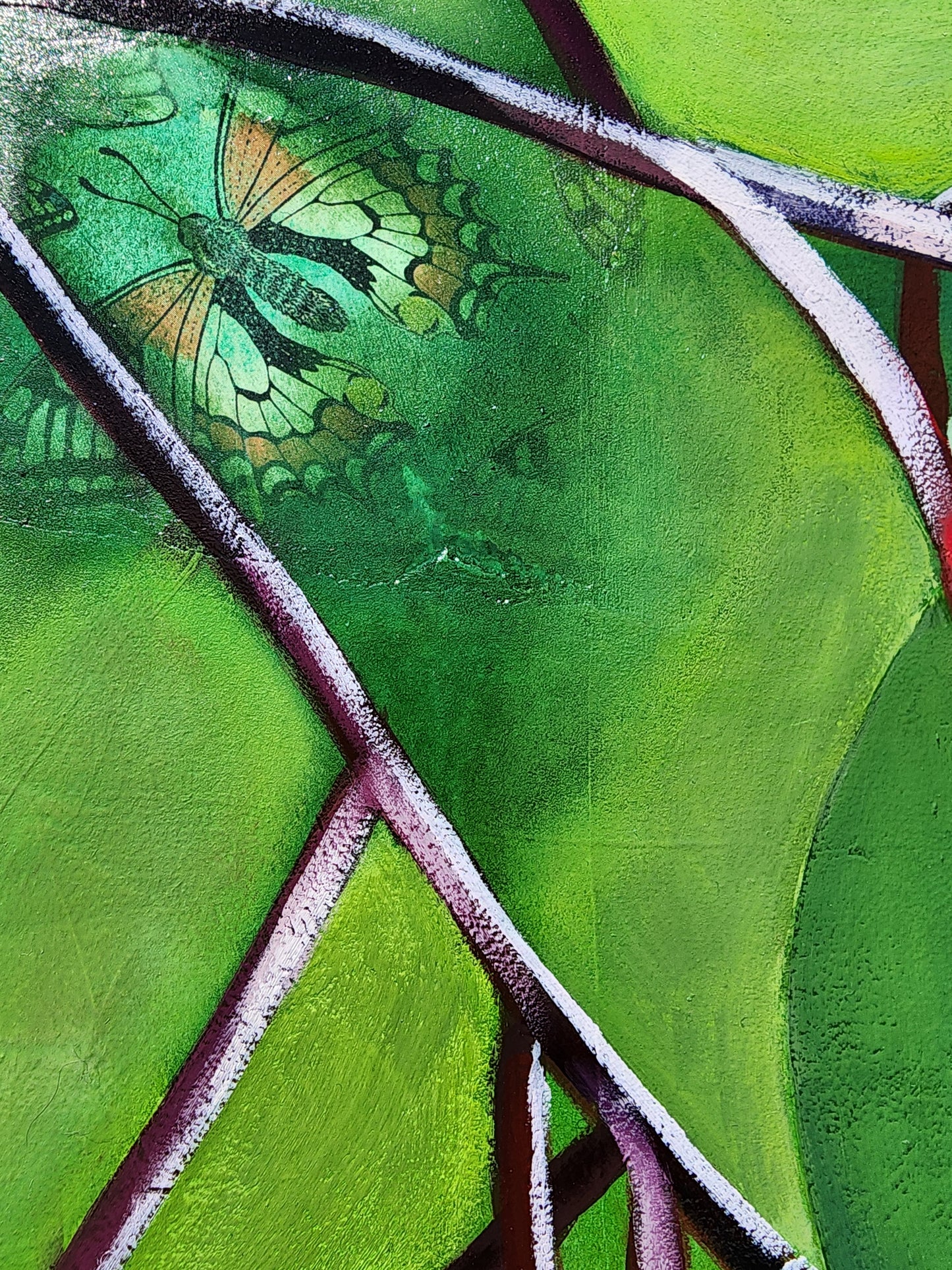Close-up of a green butterfly on a textured green surface with purple veins.