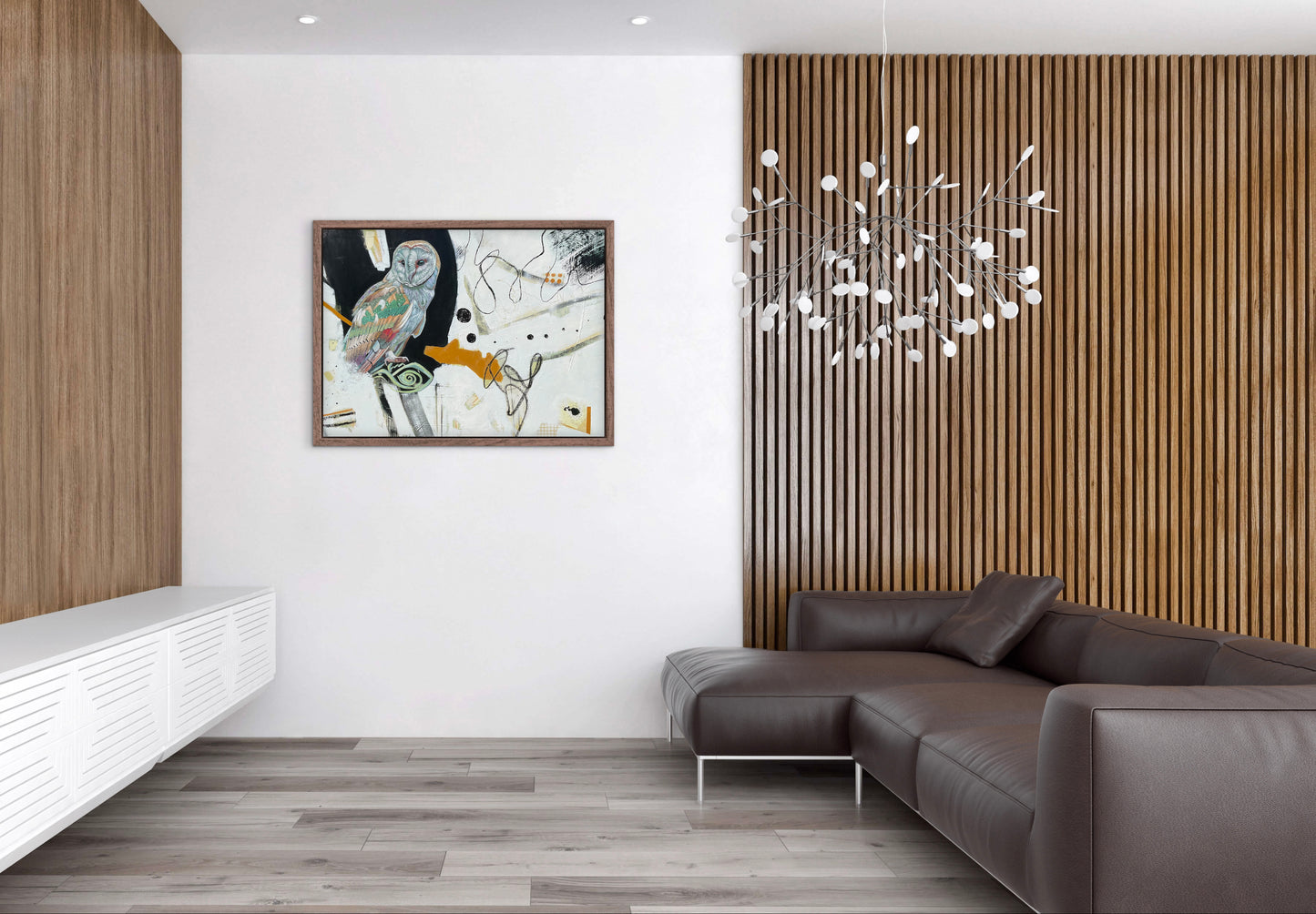 Modern living room with a brown leather sofa, wooden wall paneling, and abstract art.