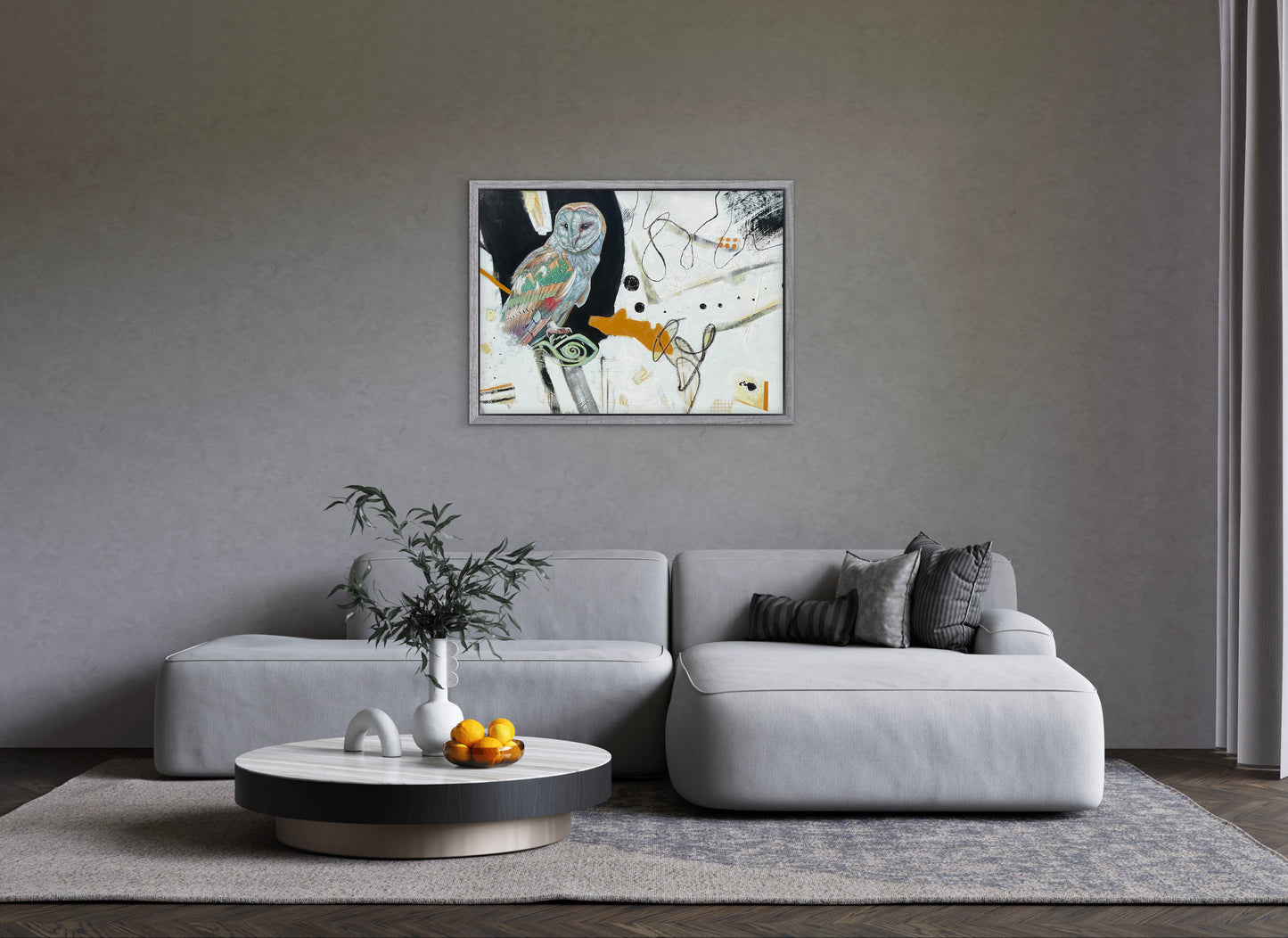 Modern living room with a gray sofa, coffee table, and abstract painting on the wall.