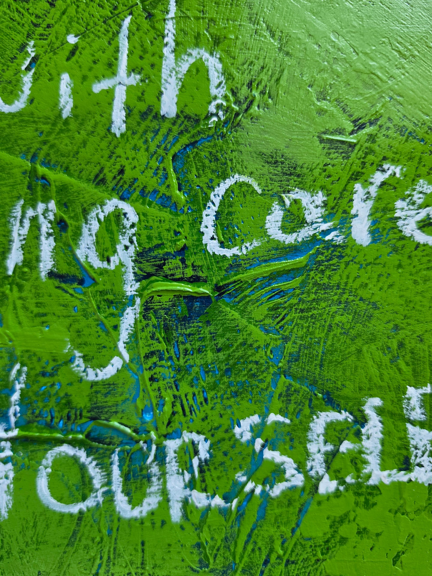 Close up of painting green and blue with pops of teal with white handwriting and texture