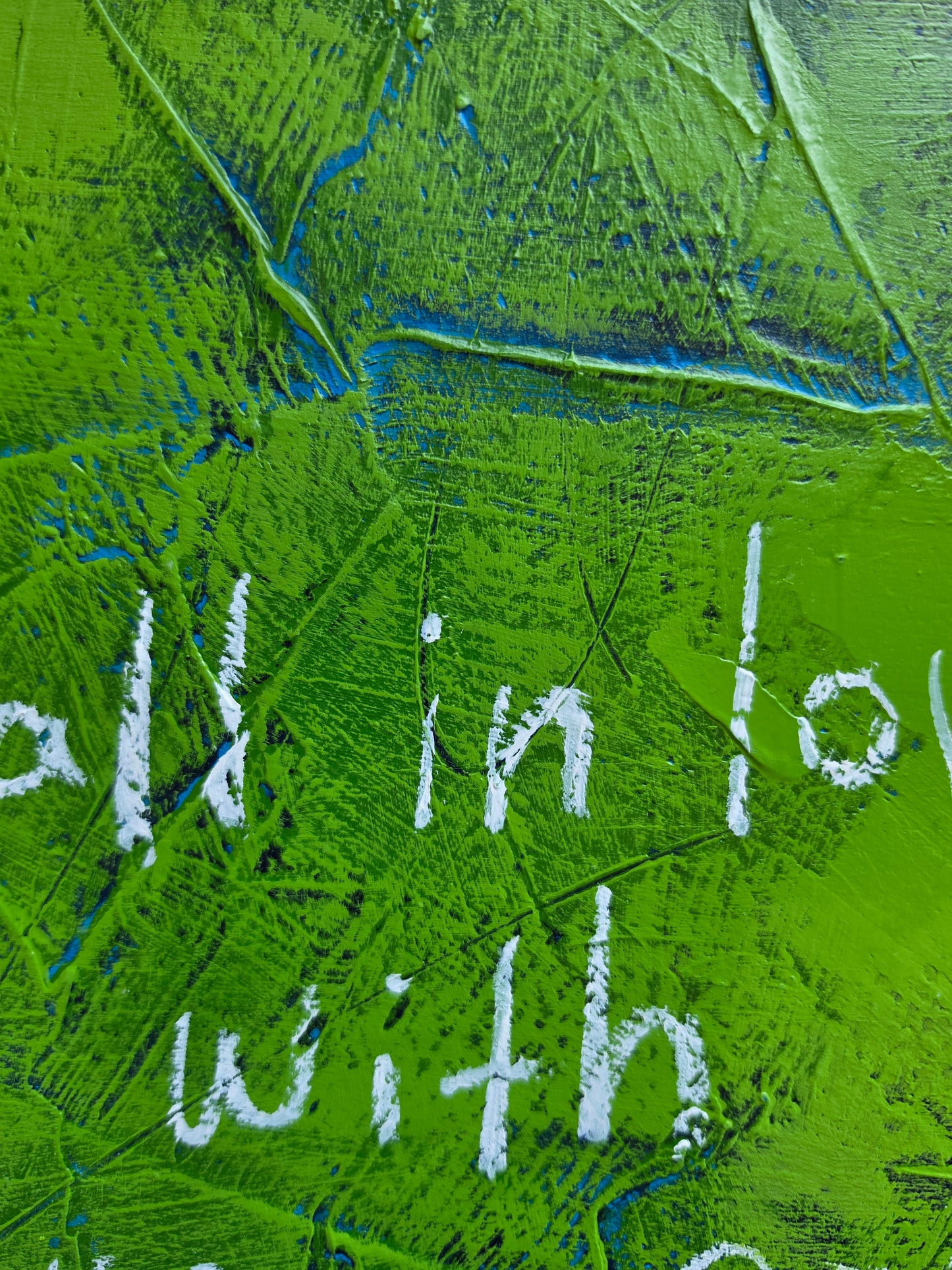 Close up of painting in green with blue and teal pops of colour with text handwritten in white 