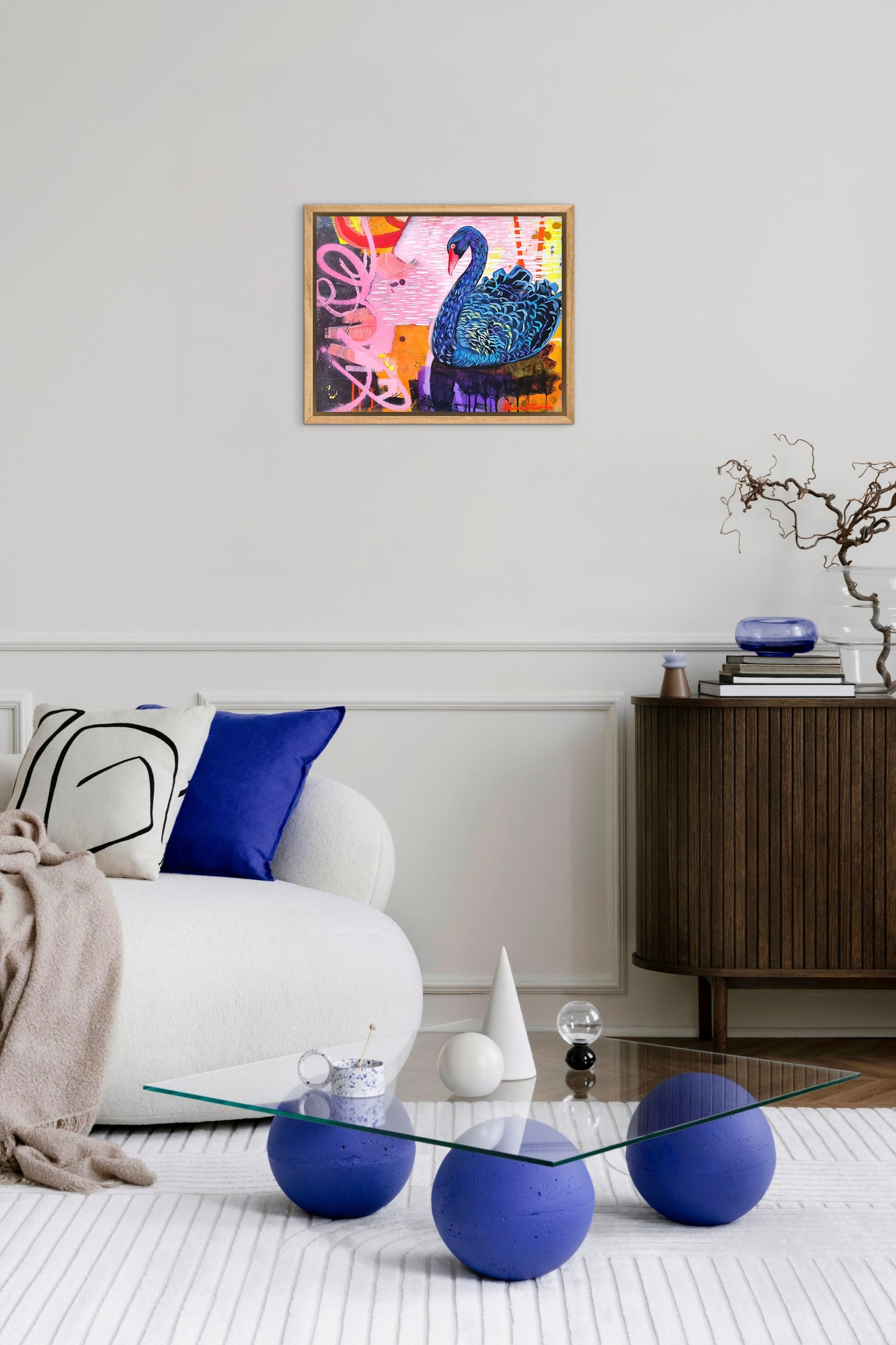 Modern living room with a colorful abstract painting of a swan on the wall.