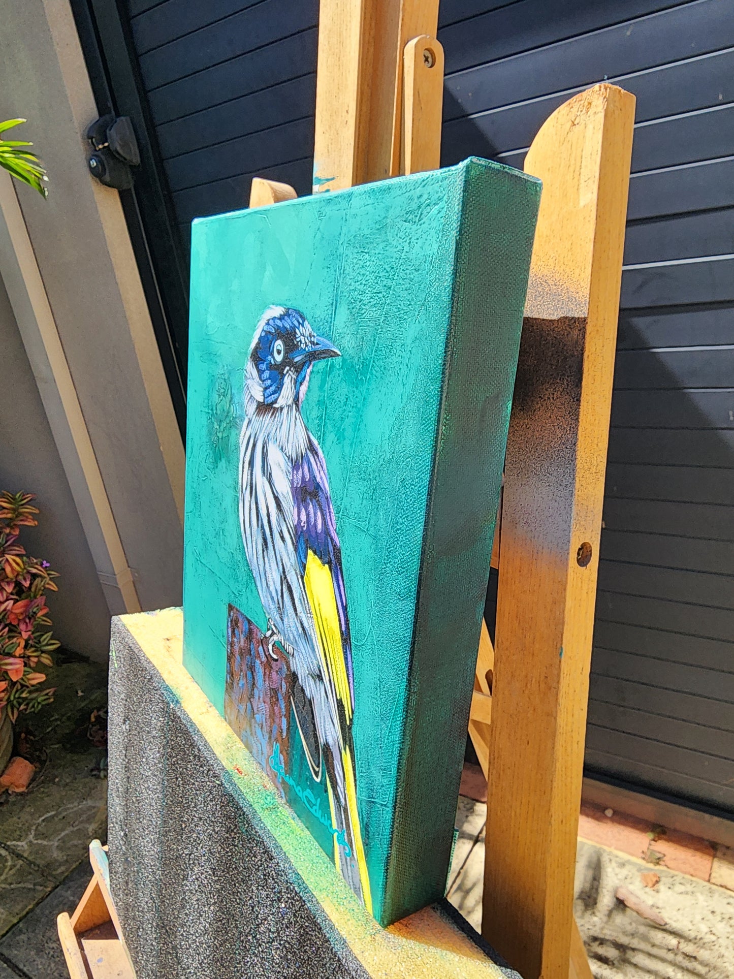Canvas with a bird painting on a wooden easel 
