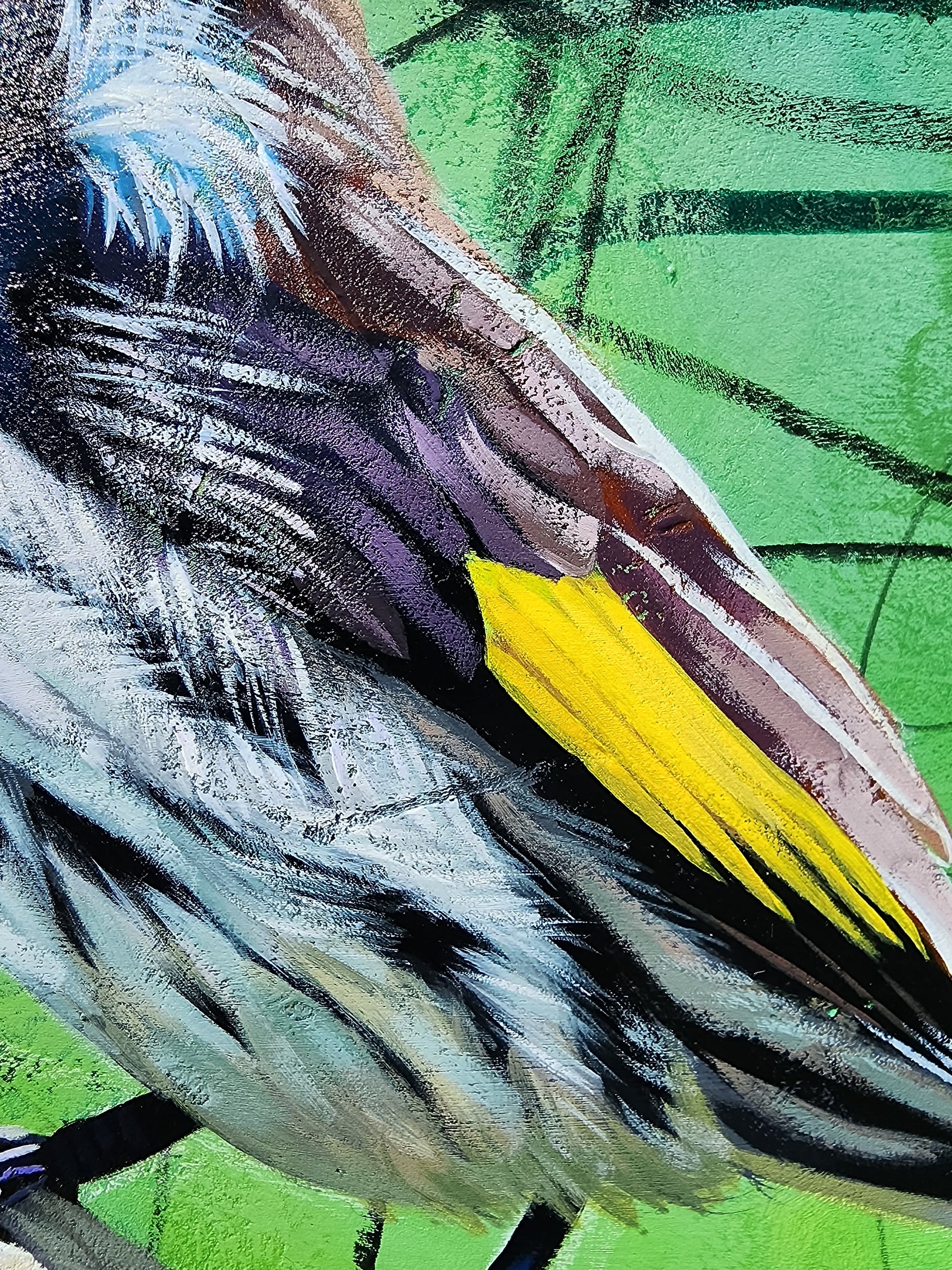 Close-up of a bird with a yellow wing against a green background
