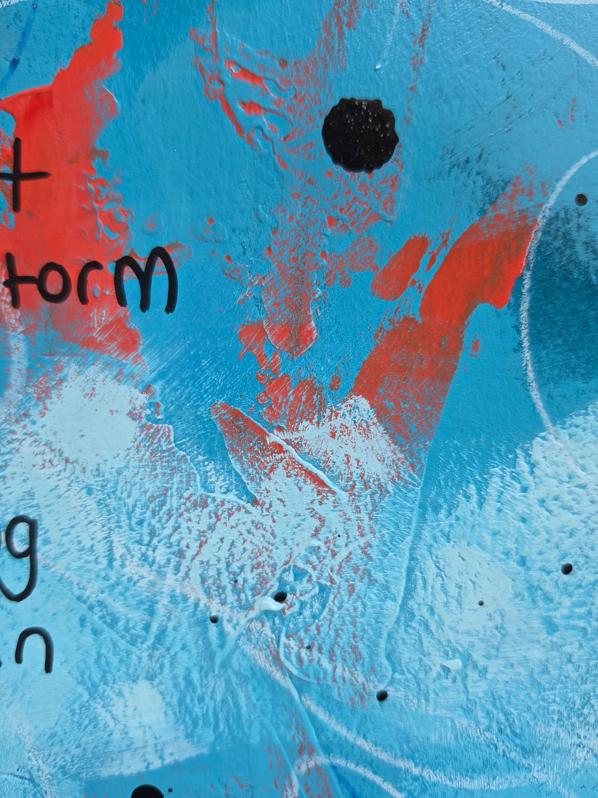 Abstract art with red and black marks and dripsa on a blue background