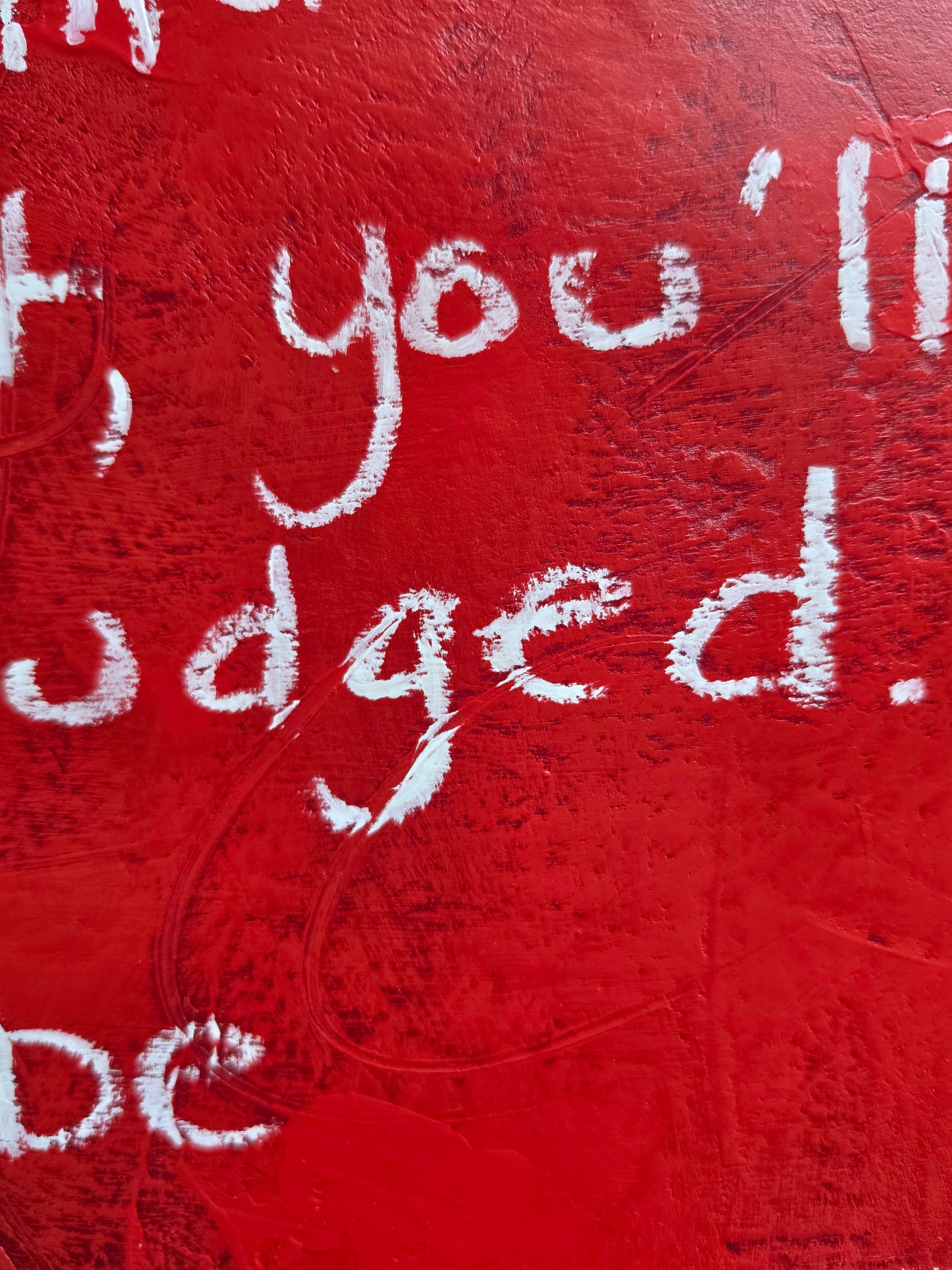 Red surface with white text on a textured background