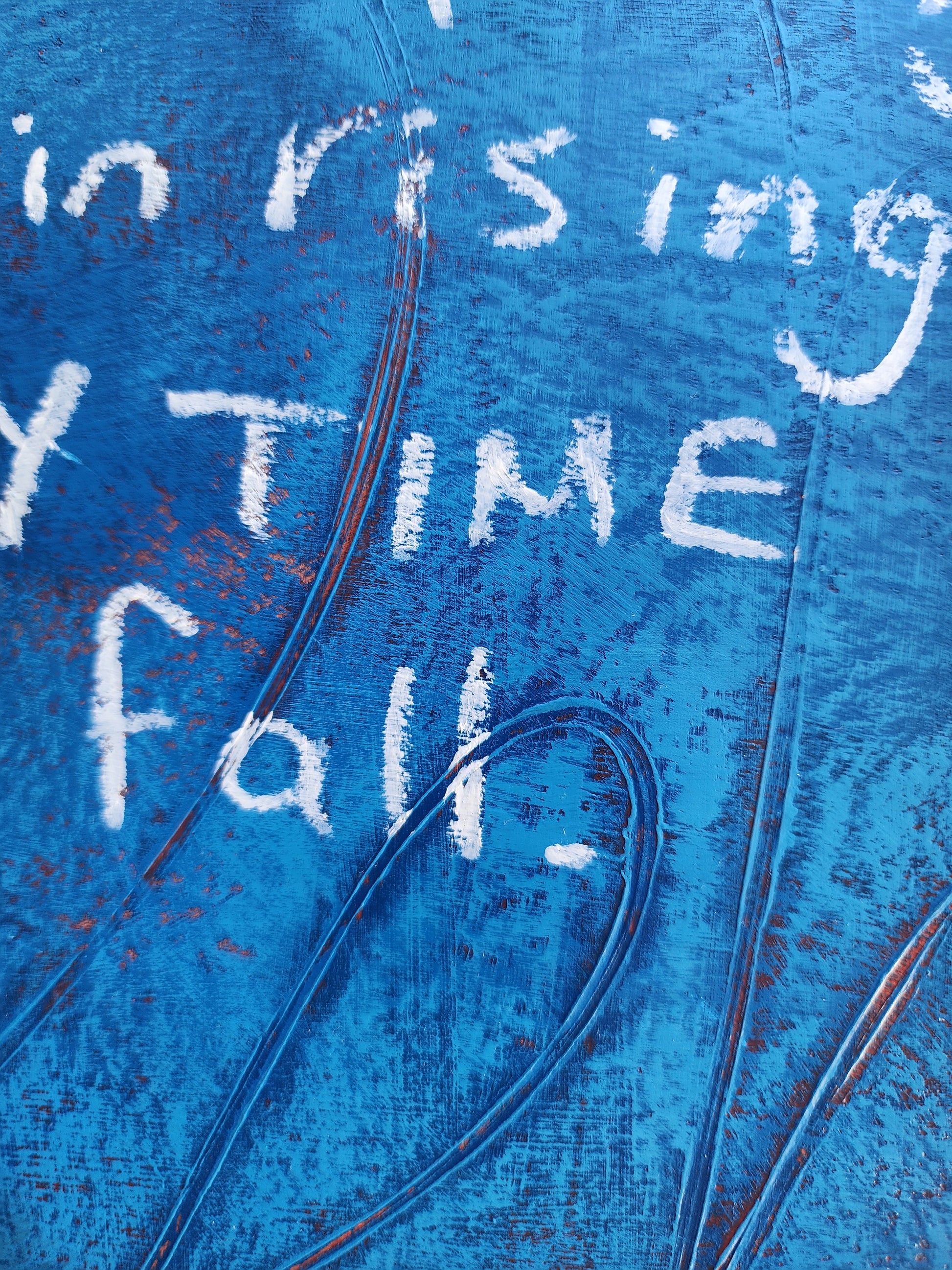 close up of painting blue textured surface with white text and abstract patterns