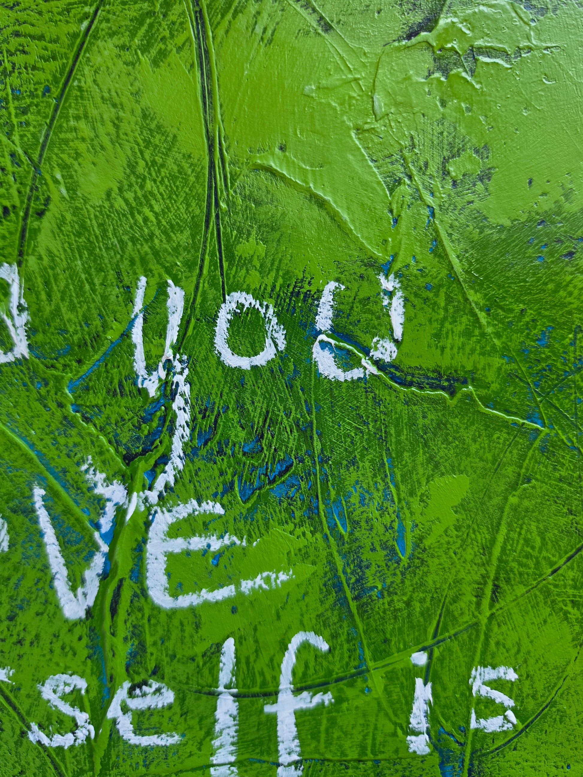 Abstract painting heavily textured in green with pops of teal and blue popping through with the words  in white handwriting close up