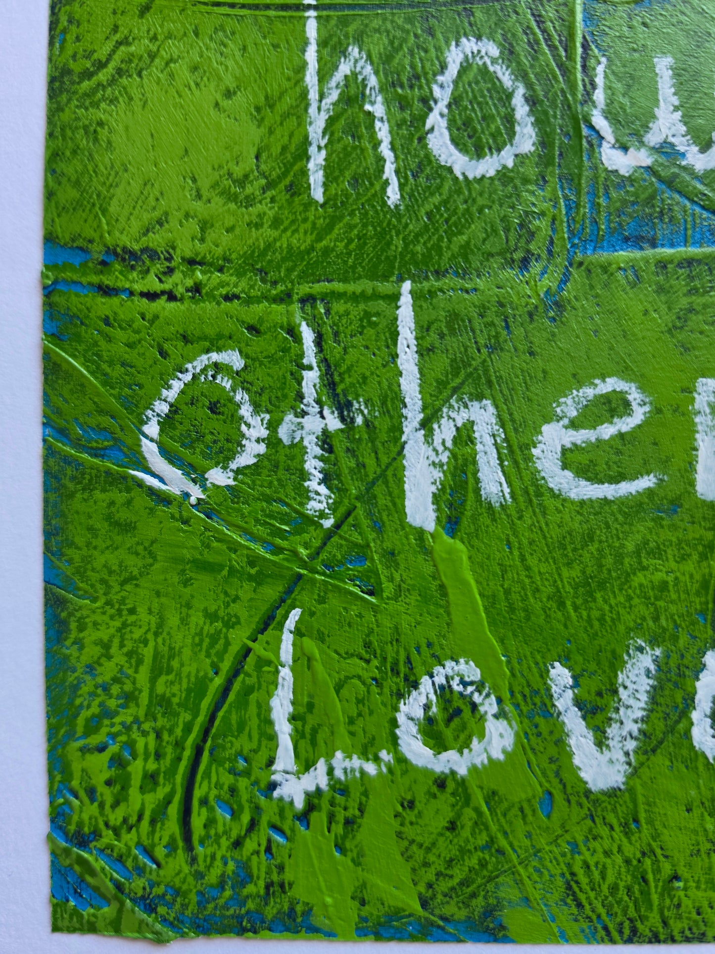 Abstract painting heavily textured in green with pops of teal and blue popping through with the words white handwriting close up