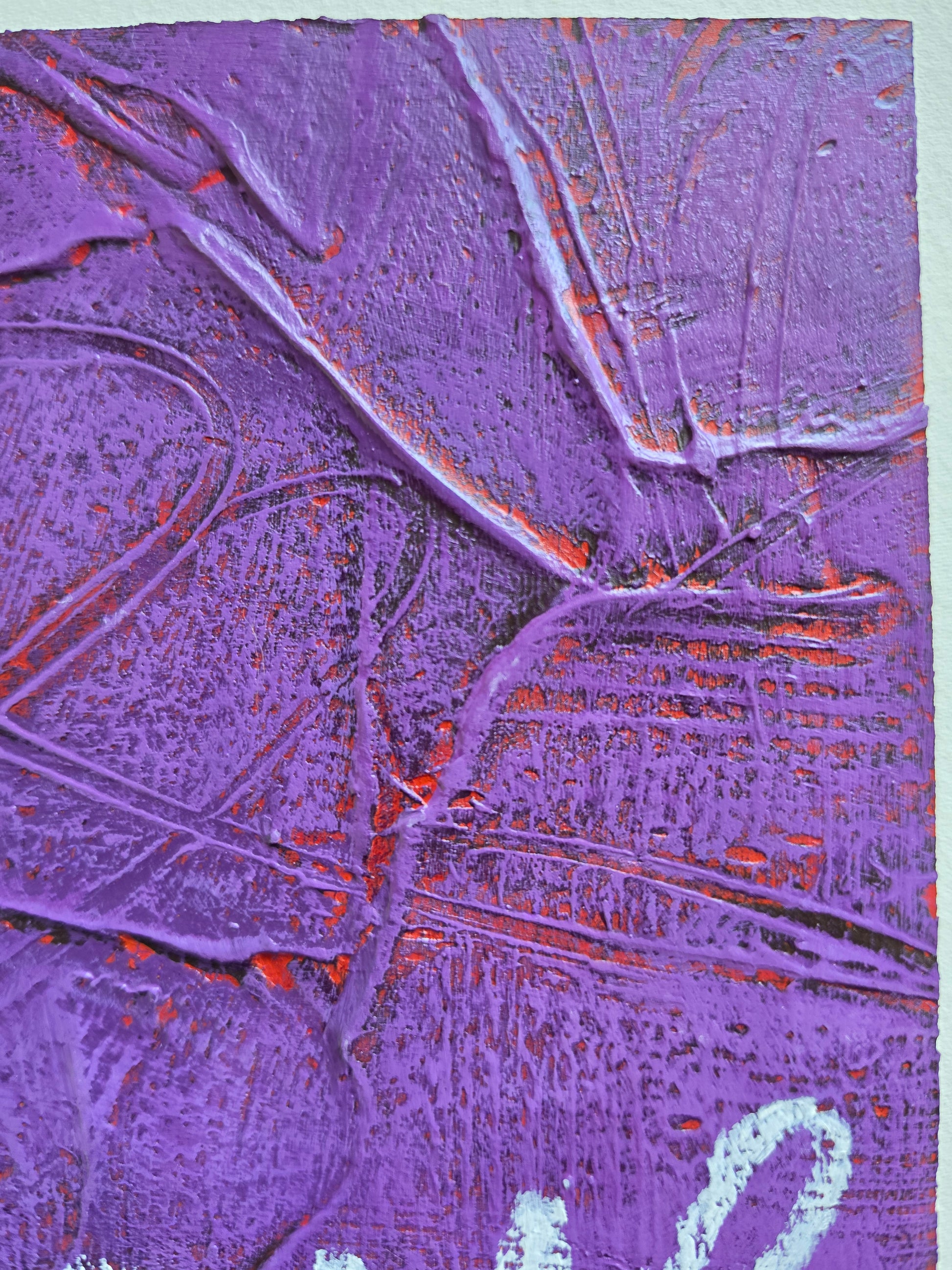Heavily textured painting in purple with pops of red coming through close up