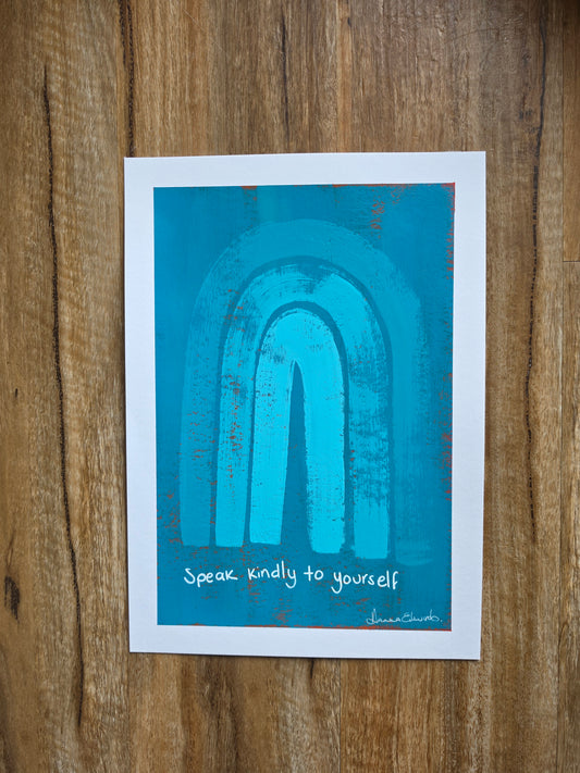 Blue painting with red popping through underneath layer with a white border featuring a textured turquoise blue abstract arch design and the handwritten quote 'Speak kindly to yourself' in white