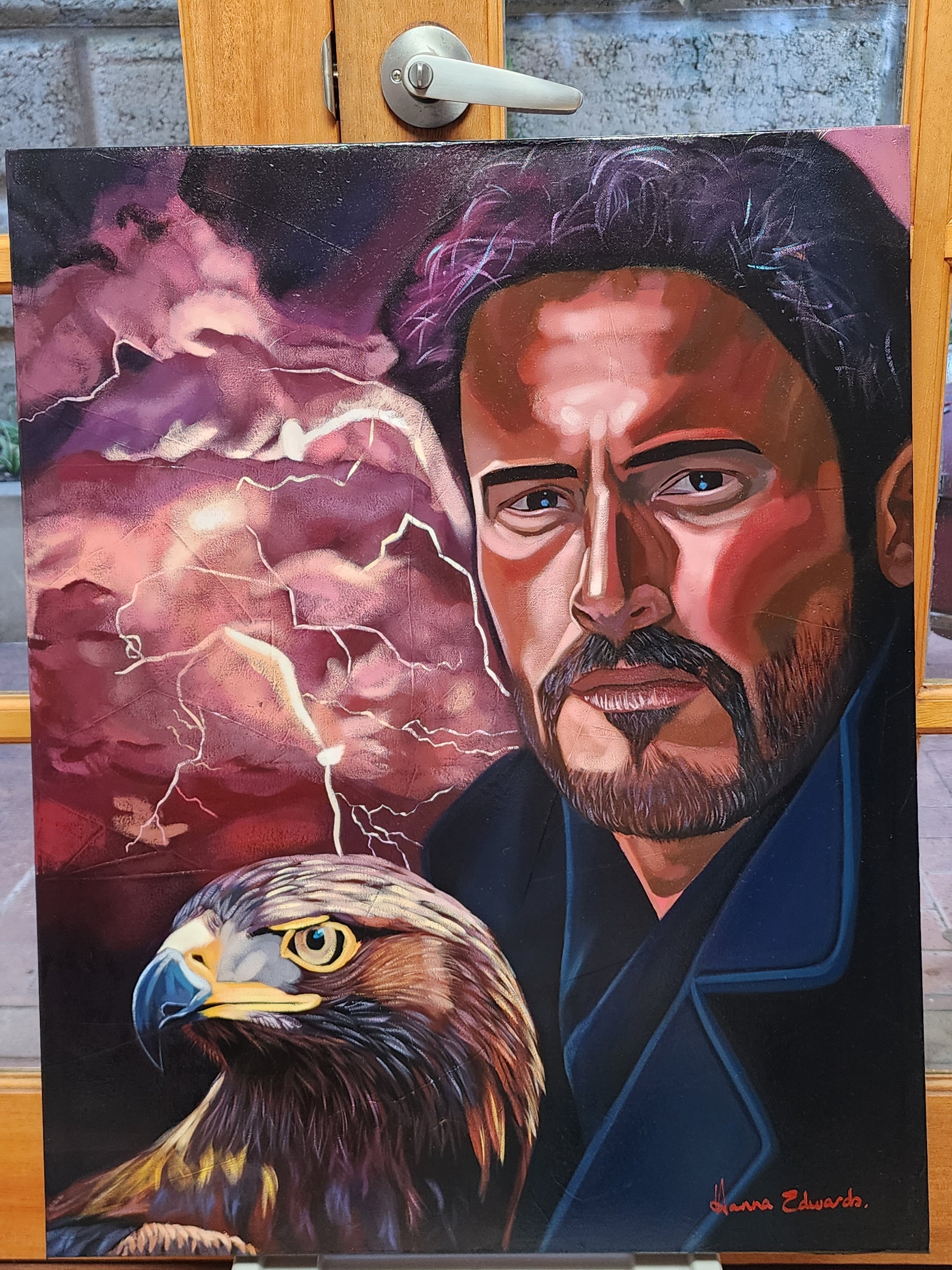 Painting of a man with a storm in the background and an an eagle by his side 