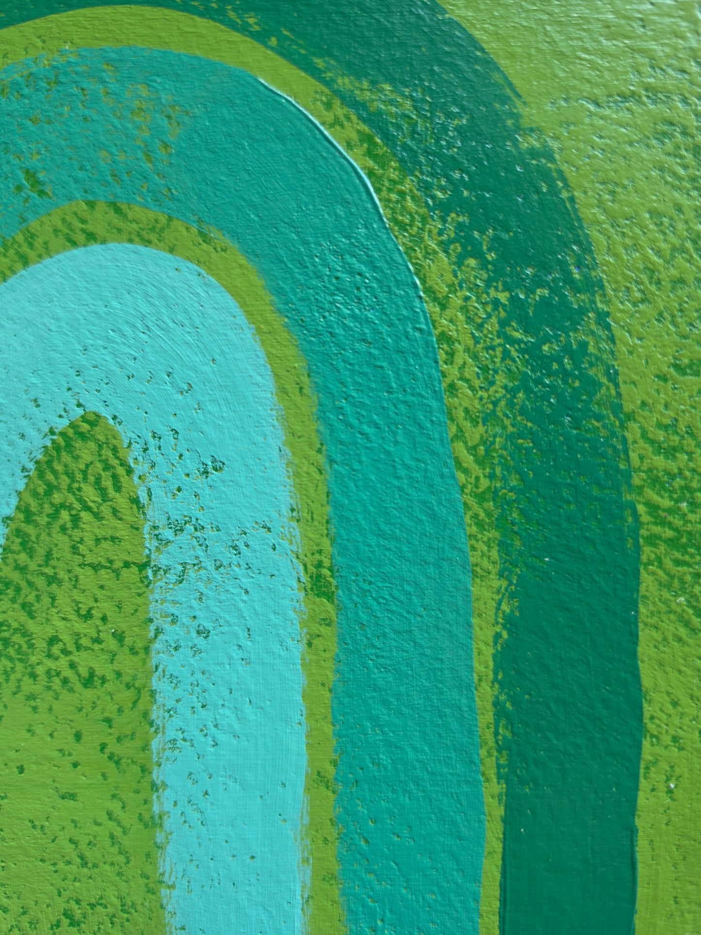 Green painting with monochromatic rainbow close up