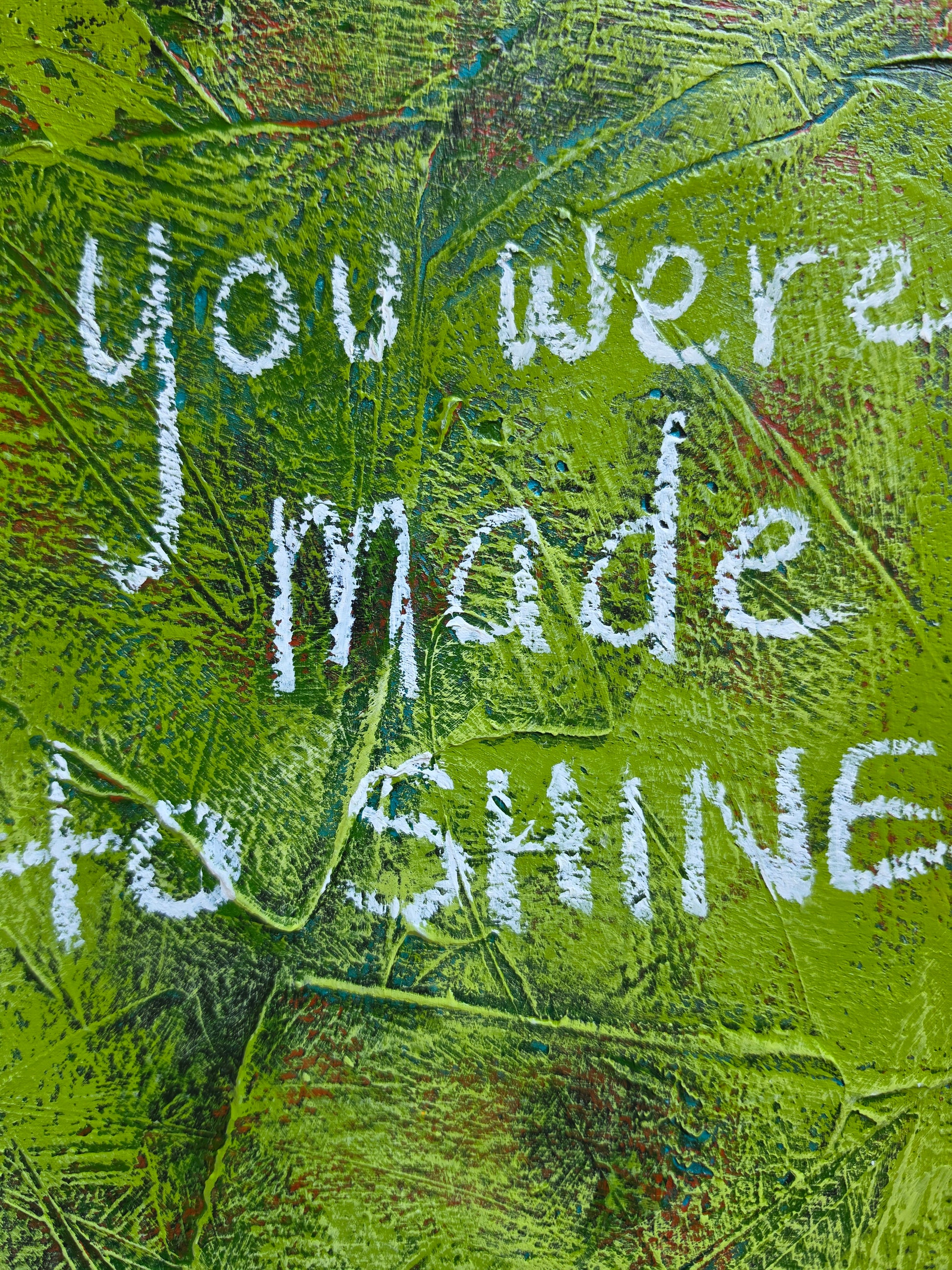 Close up of Abstract painting in green with pops of green , teal and red with the words You Were Made to Shine handwritten in white