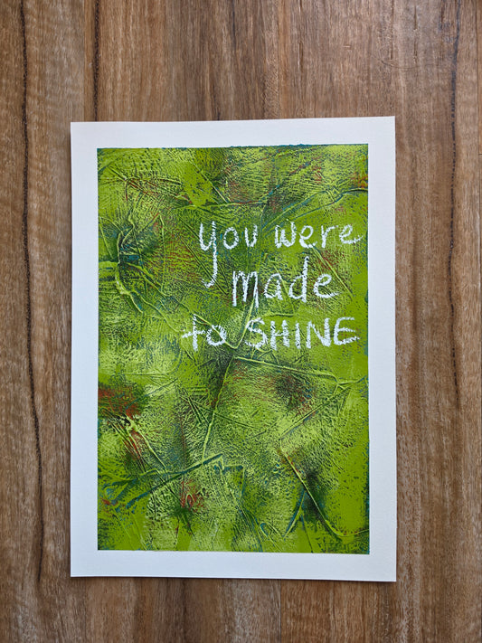 Abstract painting in green with pops of green , teal and red with the words You Were Made to Shine handwritten in white